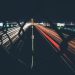 Long-exposure light trails from cars on a highway at night
